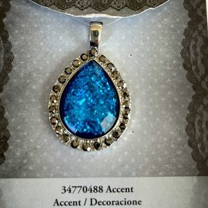 Beautiful blue pendant with shiny Crystals around it